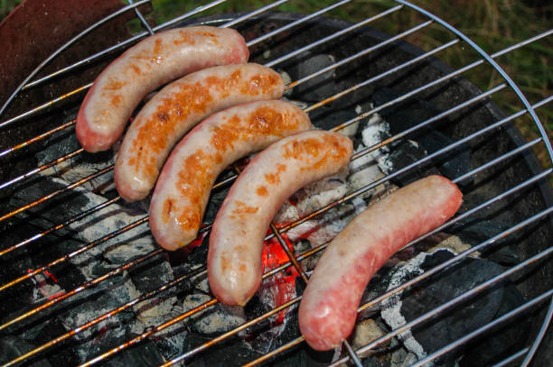 Grilled German sausages, golden on the fire.