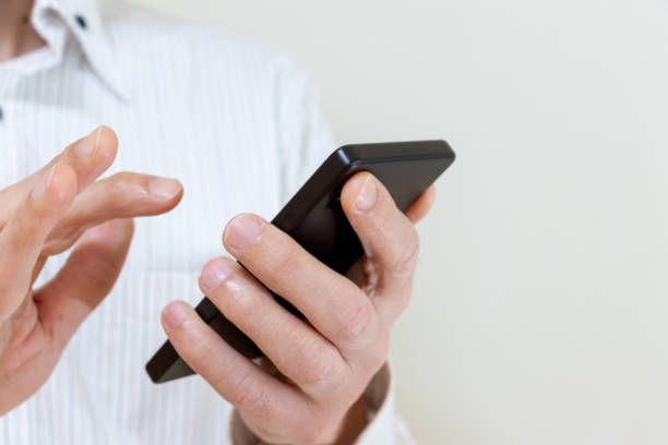 istock A man in a white shirt using a smartphone 2009226357