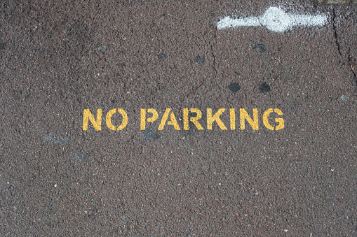 No parking written on a section of the road in yellow paint.