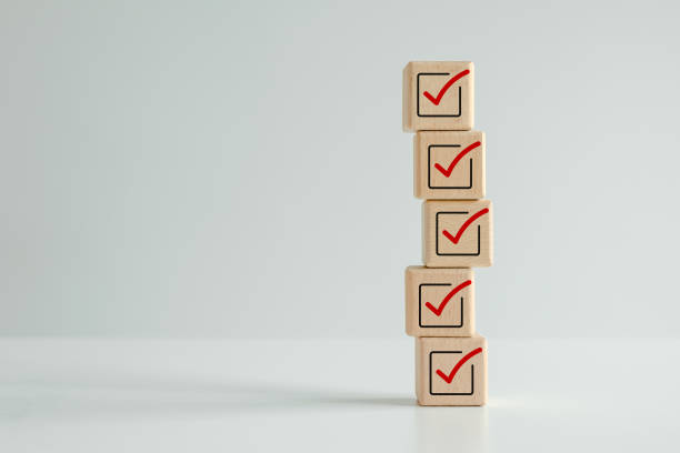istock Checklist, Task list, Survey and assessment. Quality Control. Goal achievement and business success. Elections and Voting, Vote, to do list. Red correct check mark icon on stack of wooden blocks. 2009249776