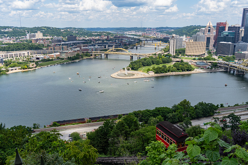 Pittsburgh, Pennsylvania - July 22, 2023: Boats gather around The Point in downtown Pittsburgh on a warm summer day