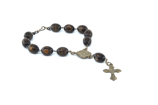 Rosary with wooden beads and a crucifix isolated on white background
