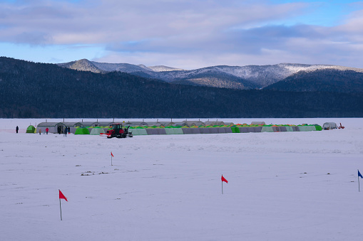 Hokkaido, Japan - January 29, 2024:  Tents on Lake Akan for Japanese pond smelt ice fishing in Hokkaido, Japan