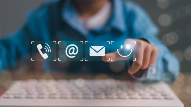istock Contact us or the Customer support hotline people connect. Businessman using a laptop and touching on virtual screen contact icons 2009361213