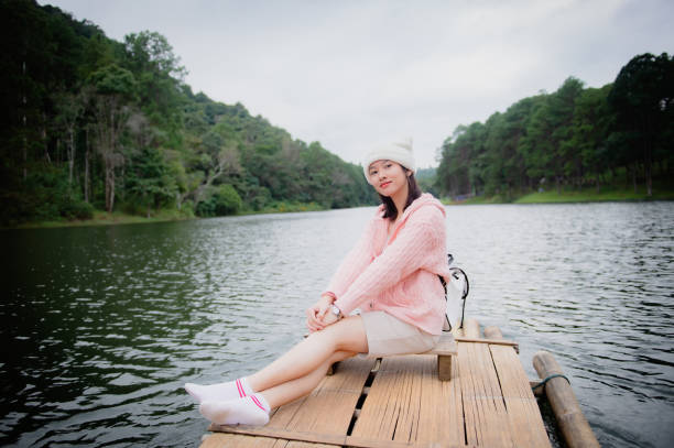 Asian woman travel nature. Travel relax.a boat photo. Sitting watching the beautiful nature at tha pom-klong-song-nam. Krabi, in Thailand.