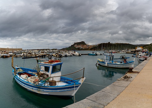 Castelsardo, Italy - 16 January, 2024: view of the port and fishing harbour of Castelsardo with the colourful town in the background