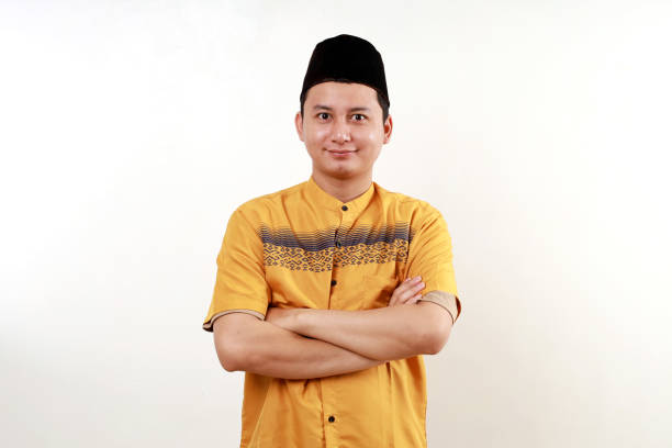 istock Young asian man wearing typical arab clothes isolated on white background who feels confident, crossing arms with determination. 2009387477