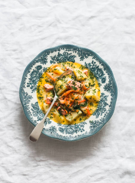 istock Creamy soup with salmon and potatoes on a light background, top view 2009401636