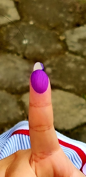 Bandung, Indonesia - Feb 14, 2024: Picture of inked finger as the sign already elect the candidate in general election day