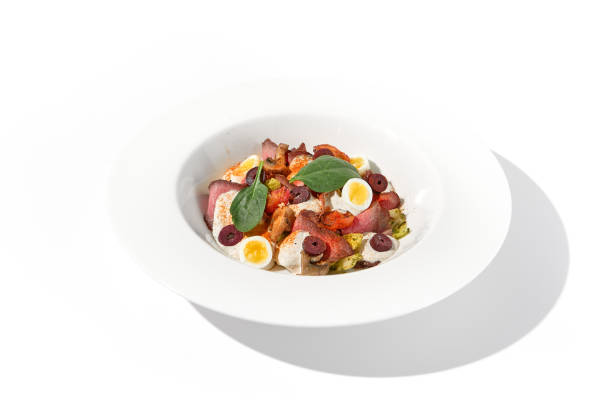 istock Roast beef salad with quail eggs and vegetables artistically arranged on a white plate 2009429632