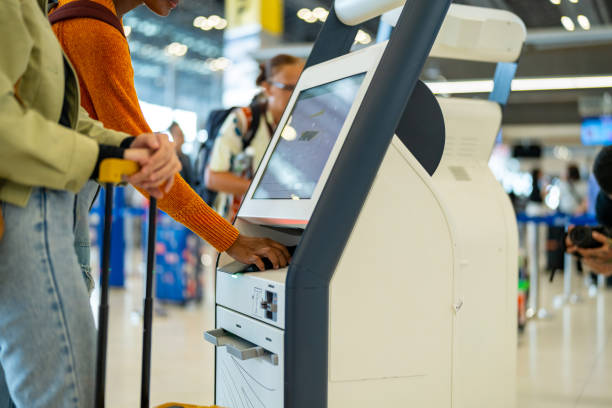 istock Two woman using self Check-in kiosk machine at airport terminal. 2009431722
