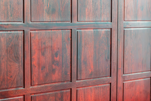 Close up view of an old medieval wooden door with bronze decoration in Malaga city, Spain, Europe