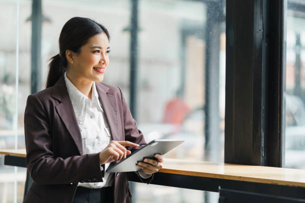 istock Confident asian businesswoman with tablet in modern office. 2009446931