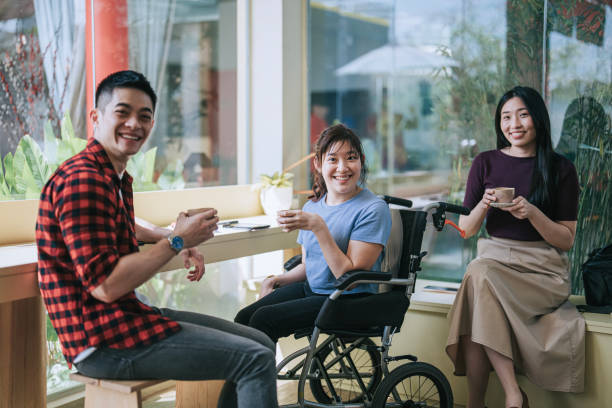 istock Asian Chinese friends looking at camera smiling in cafe 2009449594