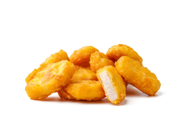istock Pile of fried chicken nuggets isolated on white 2009509853