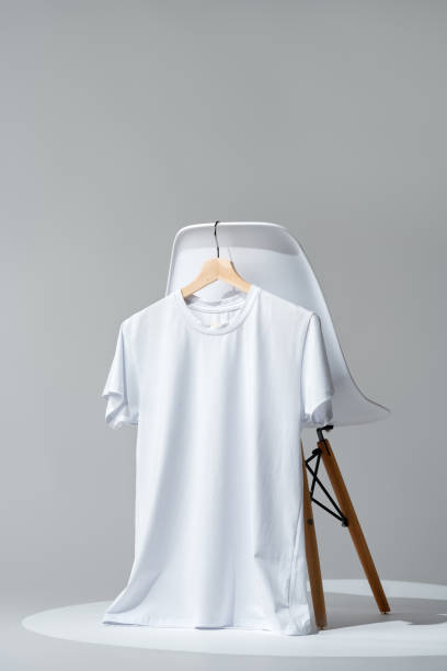 istock White blank t-shirt hanging on chair in empty room 2009517759