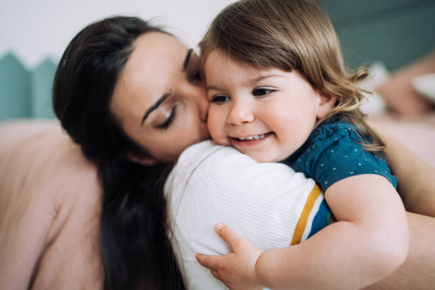 istock Affectionate mother and daughter embracing at home. 2009524030