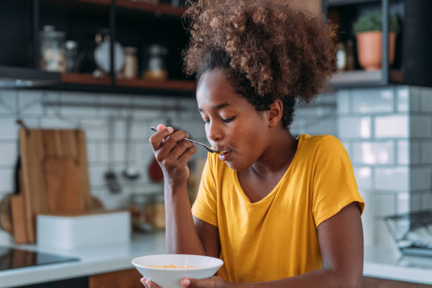 istock Happy girl having breakfast at home. 2009527698