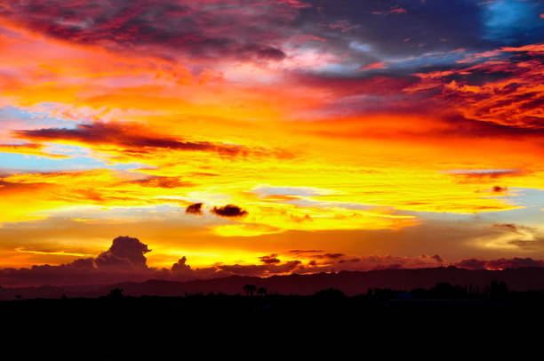 An image of warm and majestic palette of colorful clouds amid the vast canvas of skies after sunset.