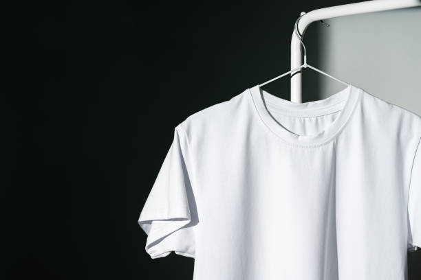 istock Blank T-shirt hanging in a spotlight in studio 2009547085