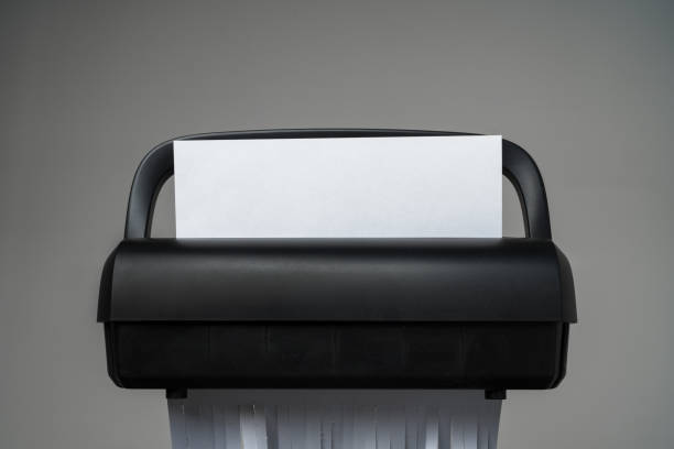 istock Black paper shredder cutting paper on gray background 2009561597