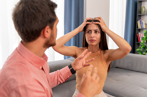 Young woman tired of arguing with her boyfriend looks hopelessly
