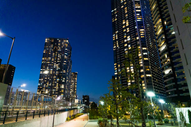 istock Night view of a high-rise condominium along an urban river 2009602748