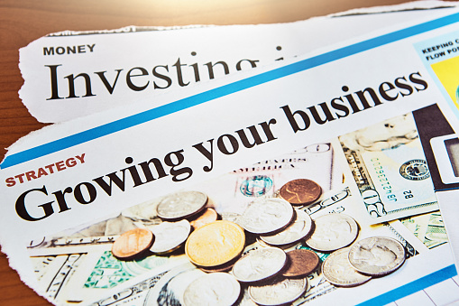 Articles torn from newspapers talk about investing and growing your business. Text, layout and photos (properly model-released) are by the photographer, so there are no copyright issues.
