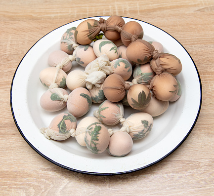 Eggs in tights with leaves. Easter