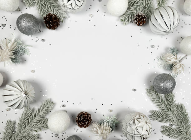 istock Christmas composition, white and silver decorations, fir tree branches, pinecones, silver stars confetti on white background. 2009639163