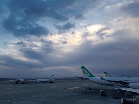 Tehran, IRAN - april 02, 2017 - Iranian airlines on the ramp of Imam Khomeini International Airport in Tehran are preparing for the start of the flight in the early morning, Airbuses of Mahan Air and Iran Air