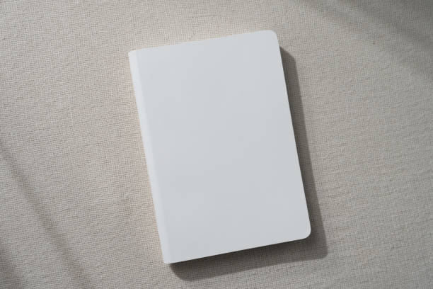 istock top view blank white book cover mockup on earthy neutral colors cloth background. with clipping path. 2009646461