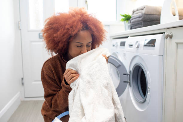 istock Young woman smelling clean clothes 2009651131