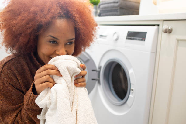 istock Young woman smelling clean clothes 2009651651