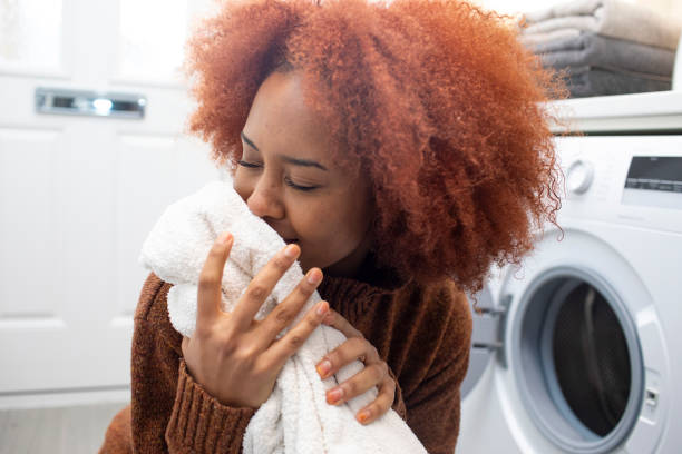 istock Young woman smelling clean clothes 2009651653