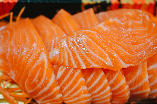 Sushi closeup isolated on white background. Sushi with algae nori rice salmon and chuka.