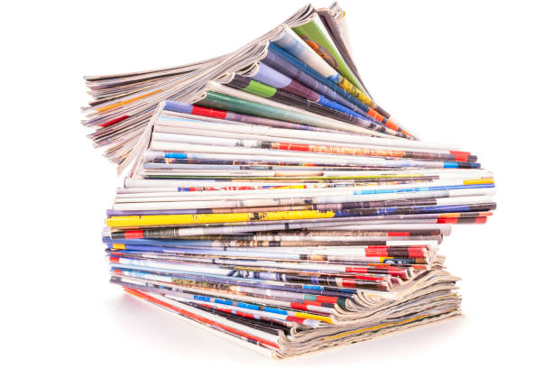 Pile of old paper magazines isolated on white background