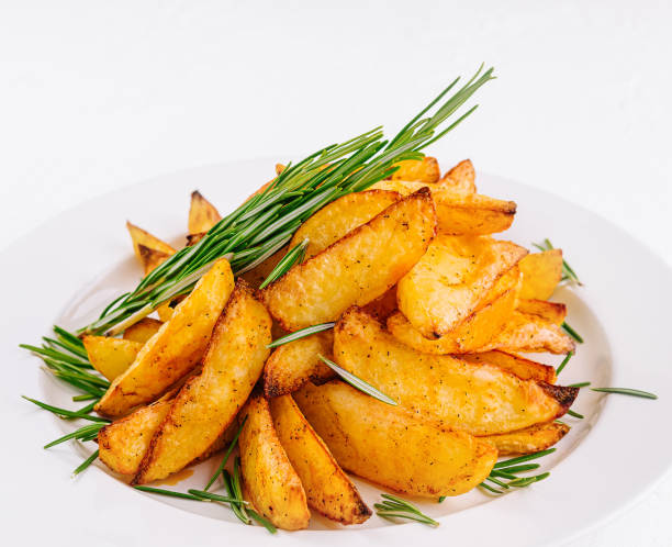 istock Baked potato wedges with rosemary on plate 2009671934