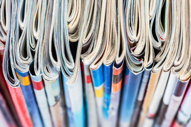 Row of magazine newspapers stacks with blur background