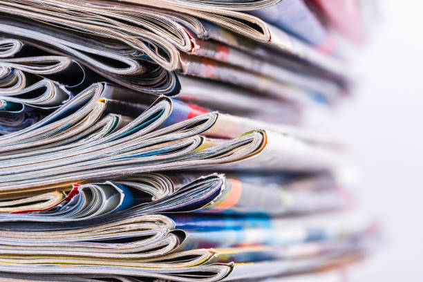 istock Pile of magazine newspapers stacks on blur background 2009680956