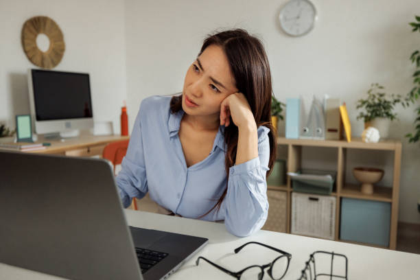 istock Tired woman having video call at home office 2009683141