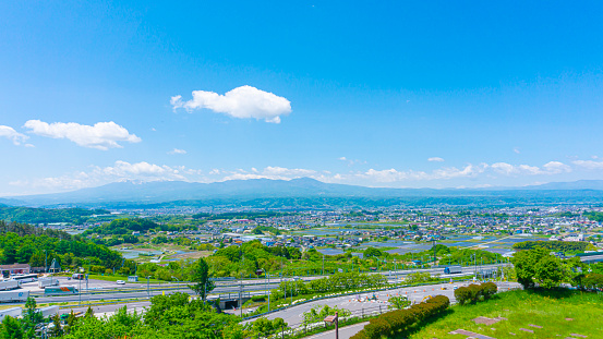 A view of the cityscape surrounded by a refreshing blue sky and nature