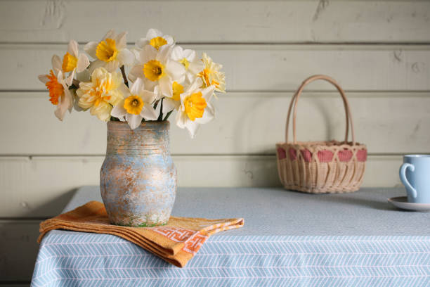istock garden yellow daffodils in a vase on the table in the cottage. Concept: Spring, Easter. 2009683683