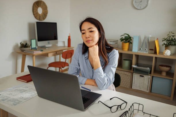 istock Young beautiful well dressed woman using laptop at home office 2009686007