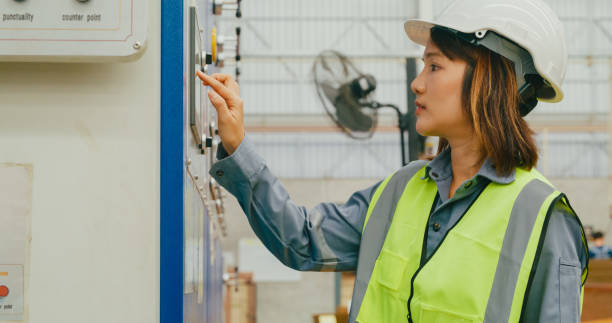 istock Professional Asian female industrial engineers operating machine keypad in manufacturing factory. Working in manufacturing plant or production plant. 2009687407