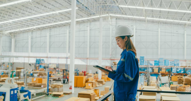 istock Professional Asian female industrial engineers use tablet while standing in manufacturing factory. Working in manufacturing plant or production plant. 2009687445