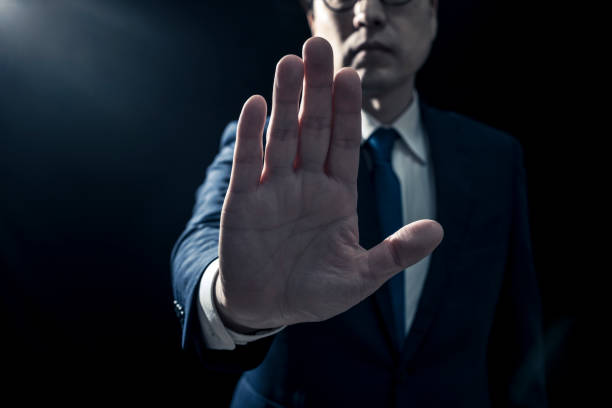 istock Businessman in Suit Gesturing 'No' with Hand Outstretched 2009689184