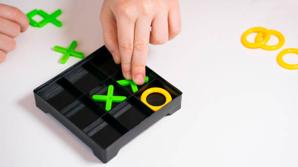A vintage-style image of a black and white Tic Tac Toe board game, featuring a 3x3 grid, placed on an old wooden table, in high resolution and sharp detail.