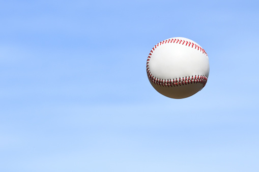 Baseball ball on clear blue sky background