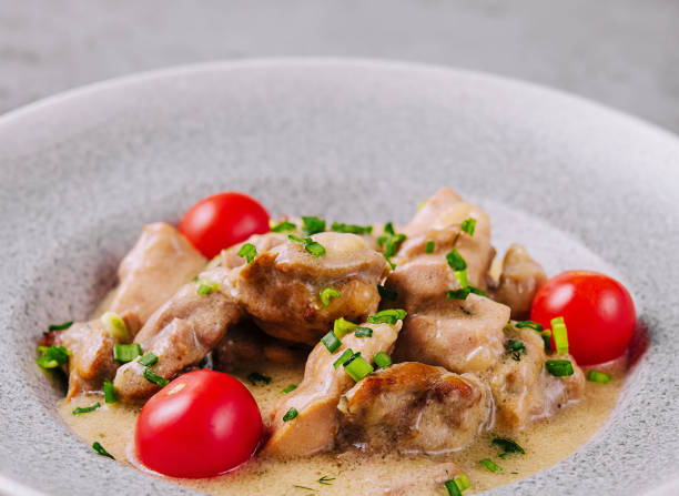 istock Grilled chicken breast with cream sauce and tomatoes 2009693500